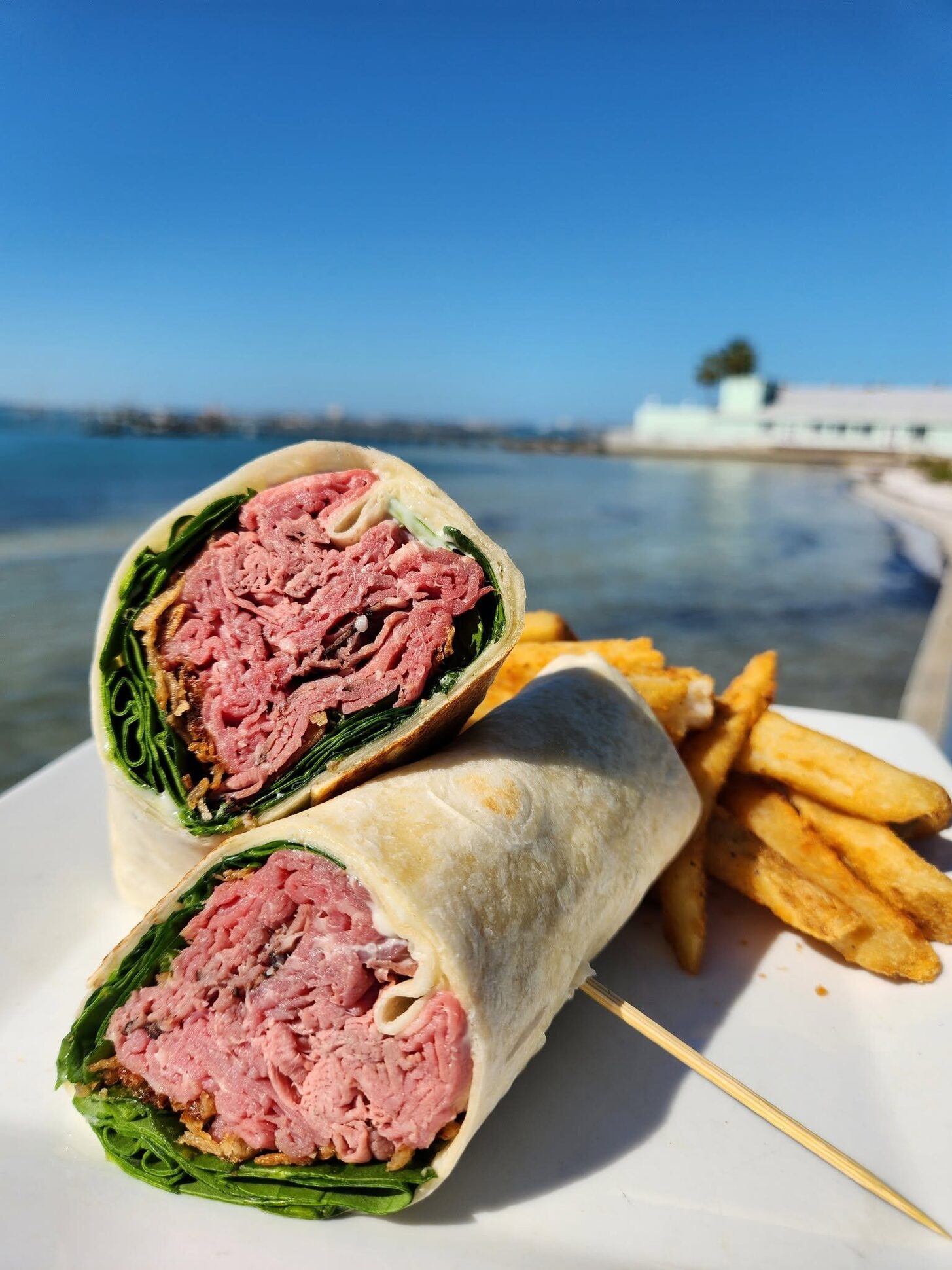 A wrap and fries with the bay behind, at O'Maddy's