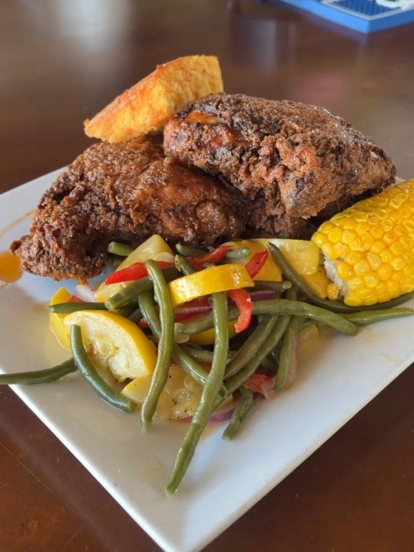 A fried chicken dinner with green beans and corn at O’Maddy’s