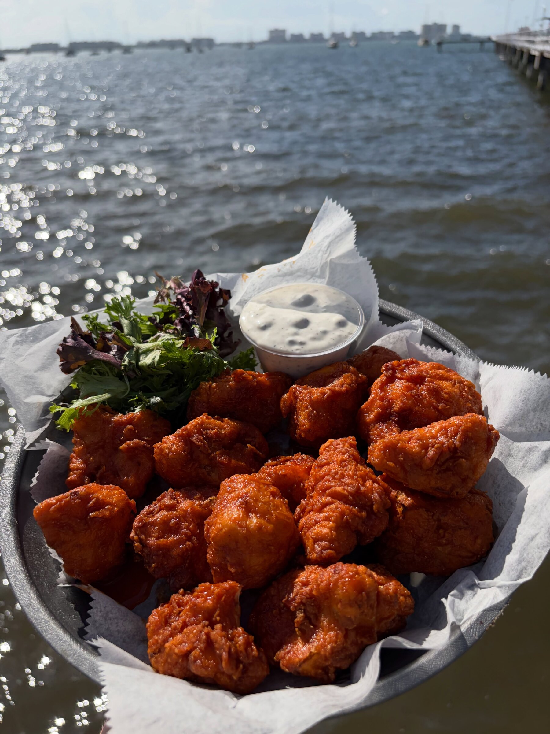 Boneless wings at O'Maddy's with the sun on the bay