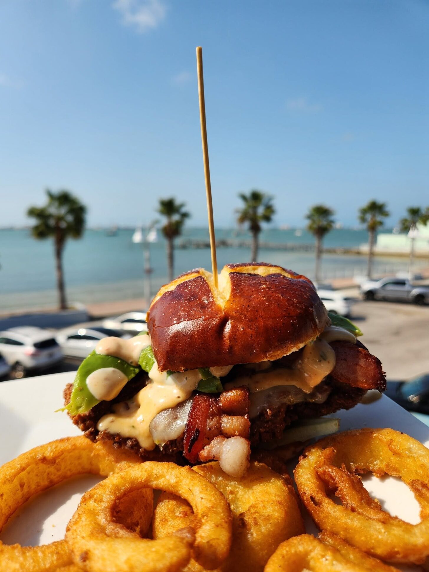 Sheri B.’s Hangover burger on the O’Maddy’s rail, palms behind